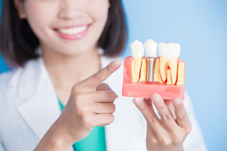 dentist with dental implant