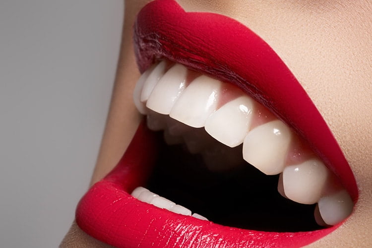 Beautiful white teeth and red lips