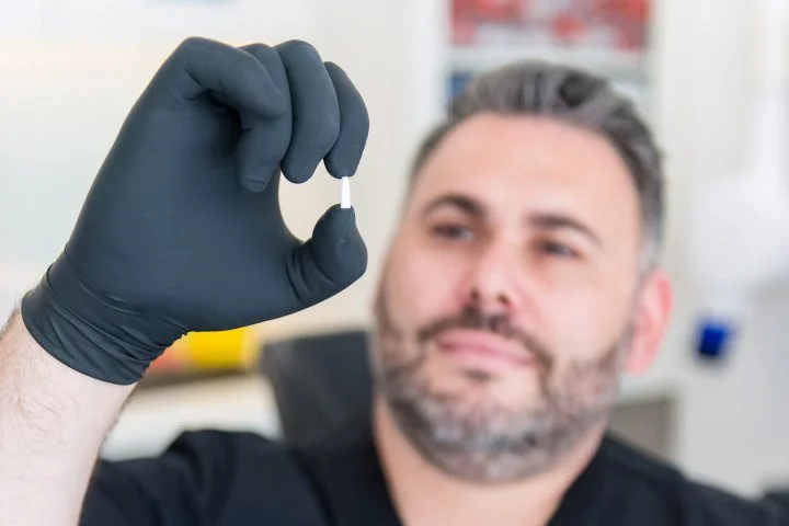 Dr. Licenblat holding Zirconia Dental Implant